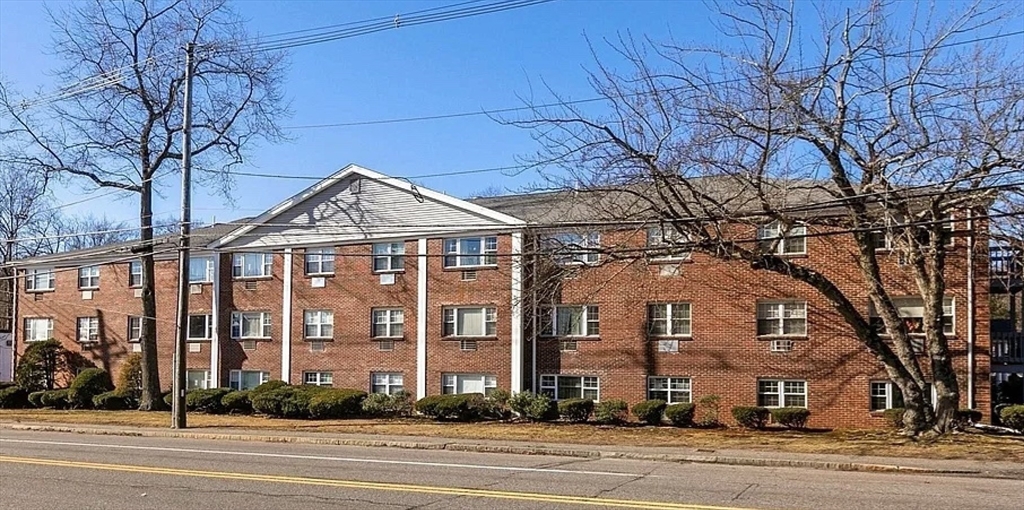 a view of a big building next to a road