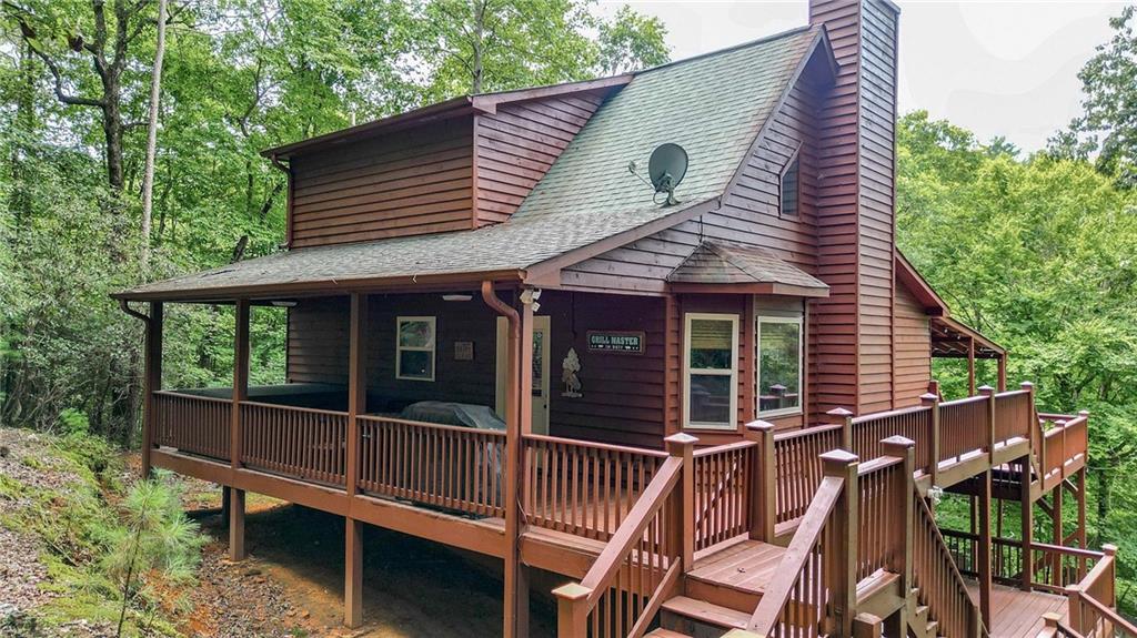 a view of a house with backyard and wooden deck