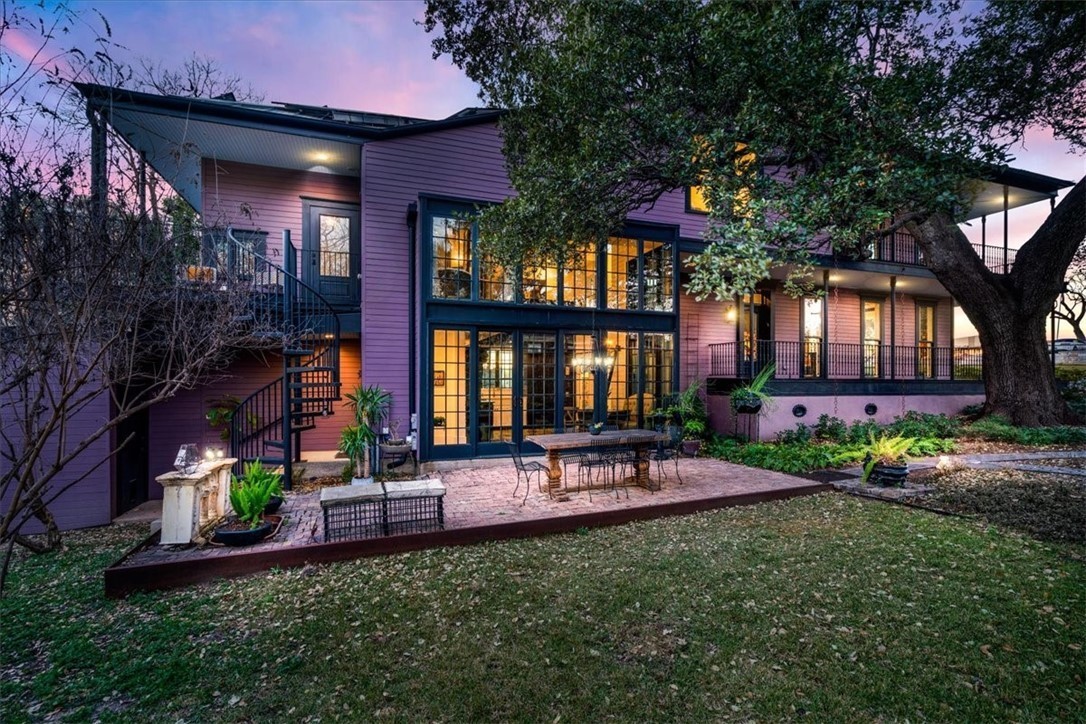 a view of a house with a yard and sitting area