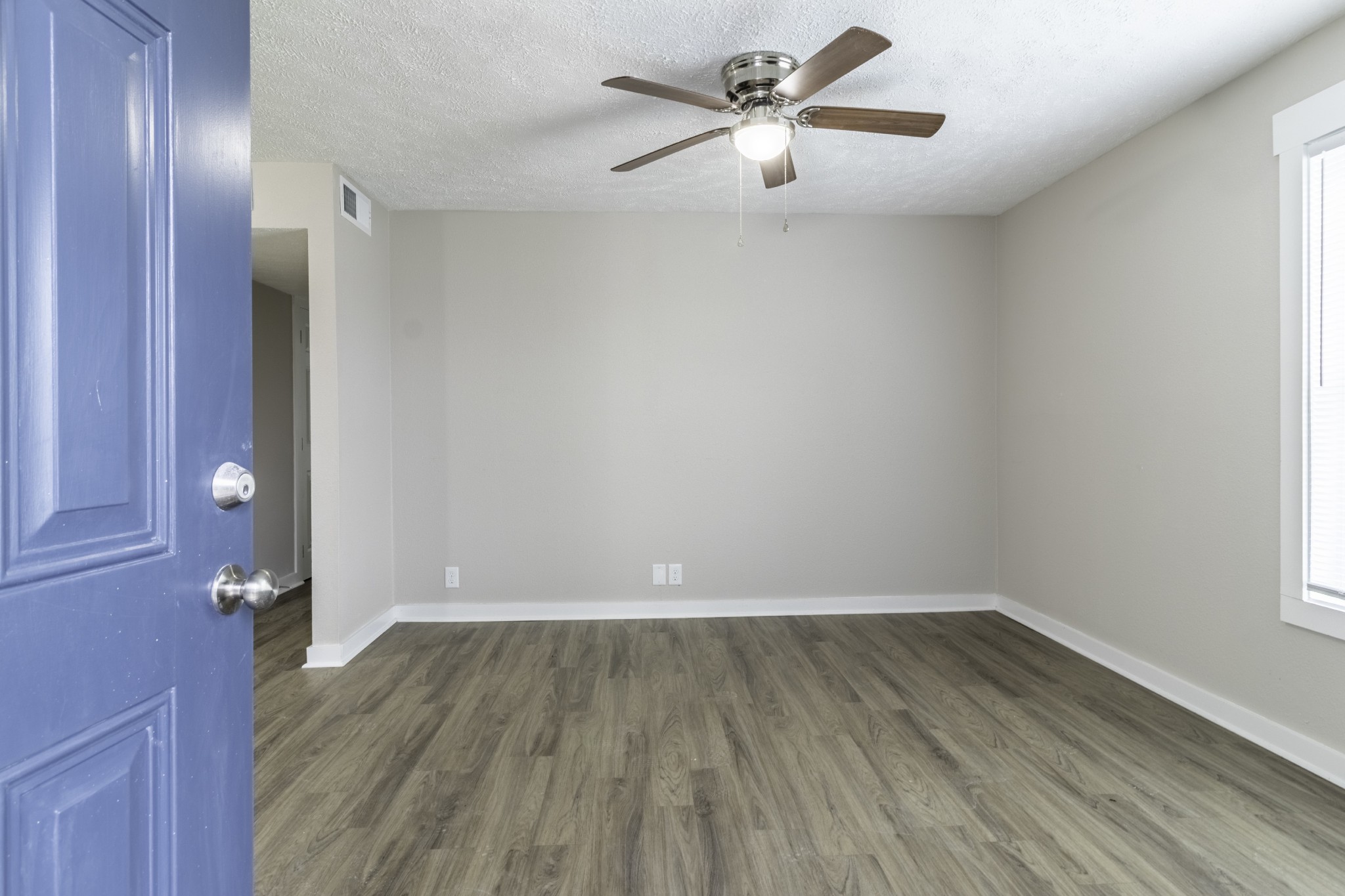 wooden floor in an empty room with a window