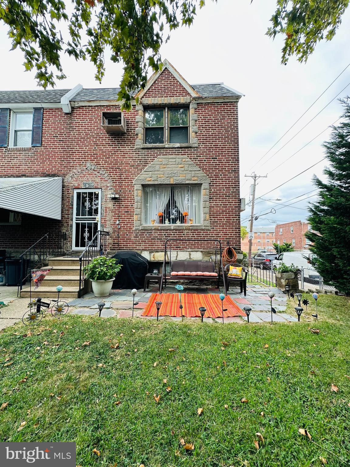 a view of a house with a yard and sitting area