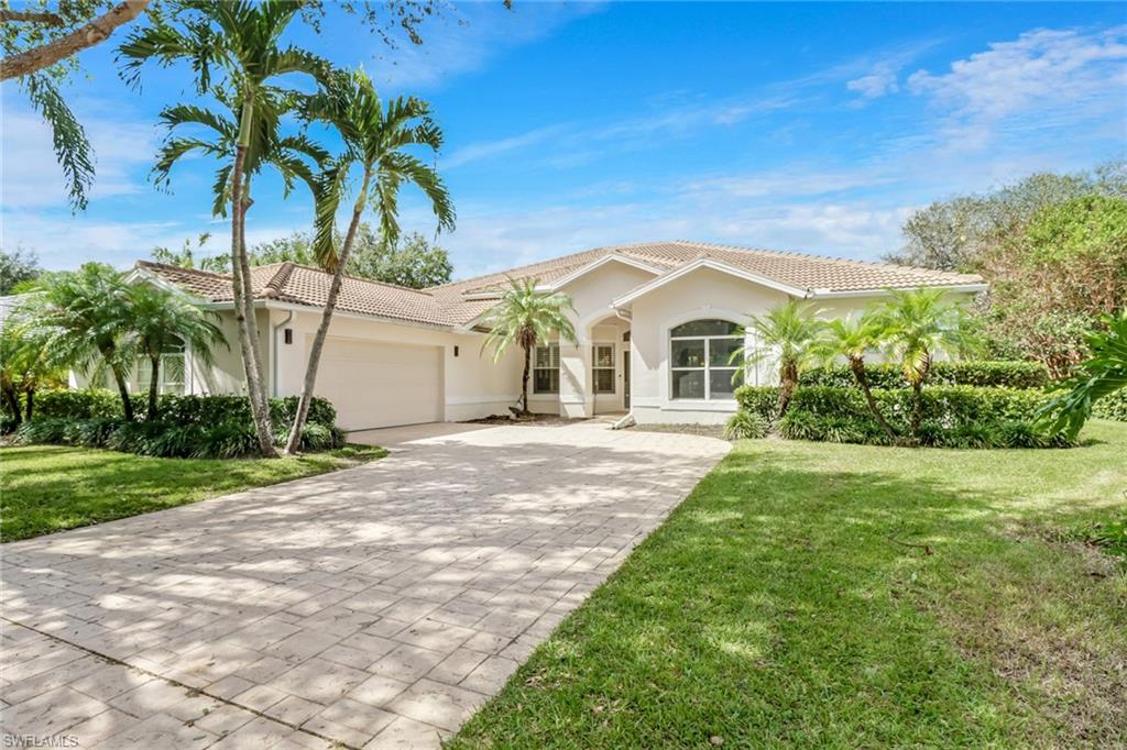 Mediterranean / spanish house with a front lawn and a garage