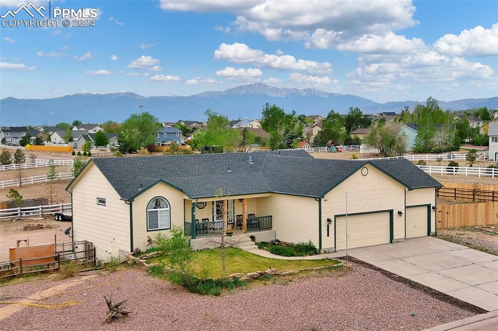 Ranch-style house with a porch and a mountain view