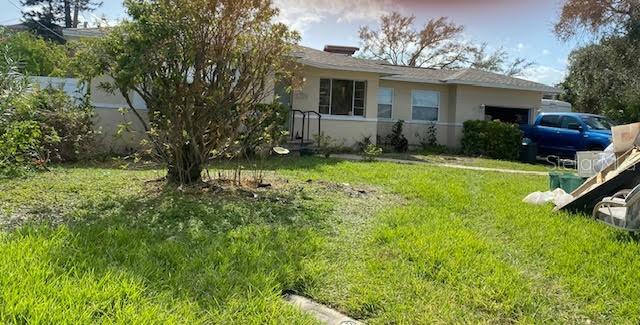 a front view of house with yard and trees