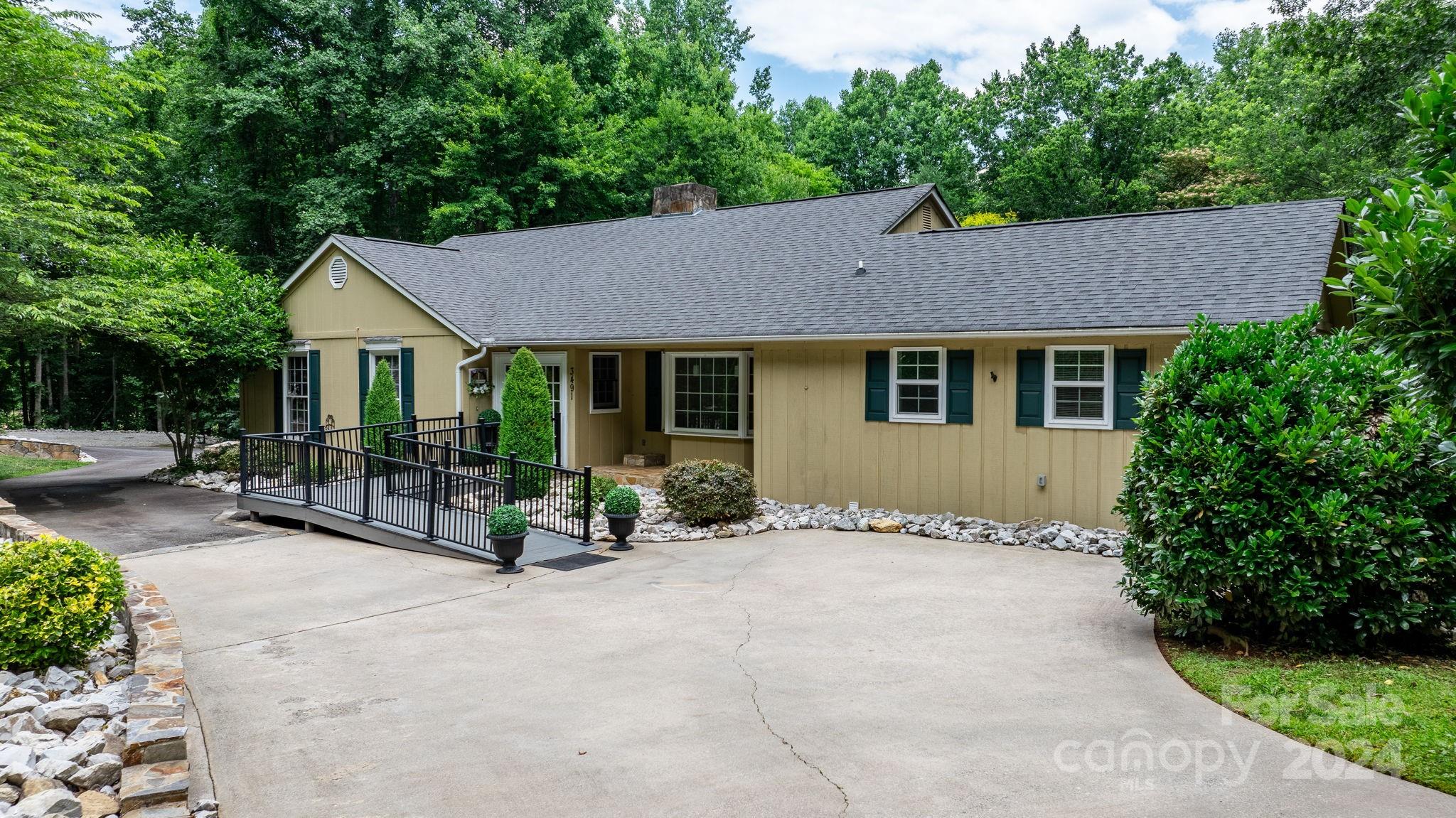 a view of a house with backyard sitting area and garden