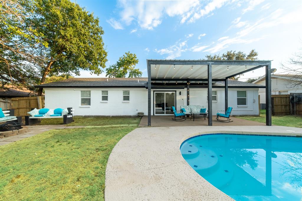 a view of a house with a swimming pool and a yard