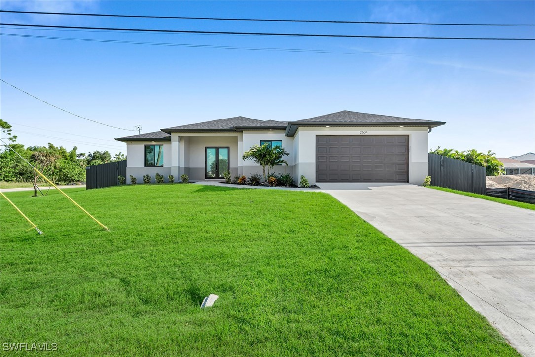 a front view of a house with a yard and garage