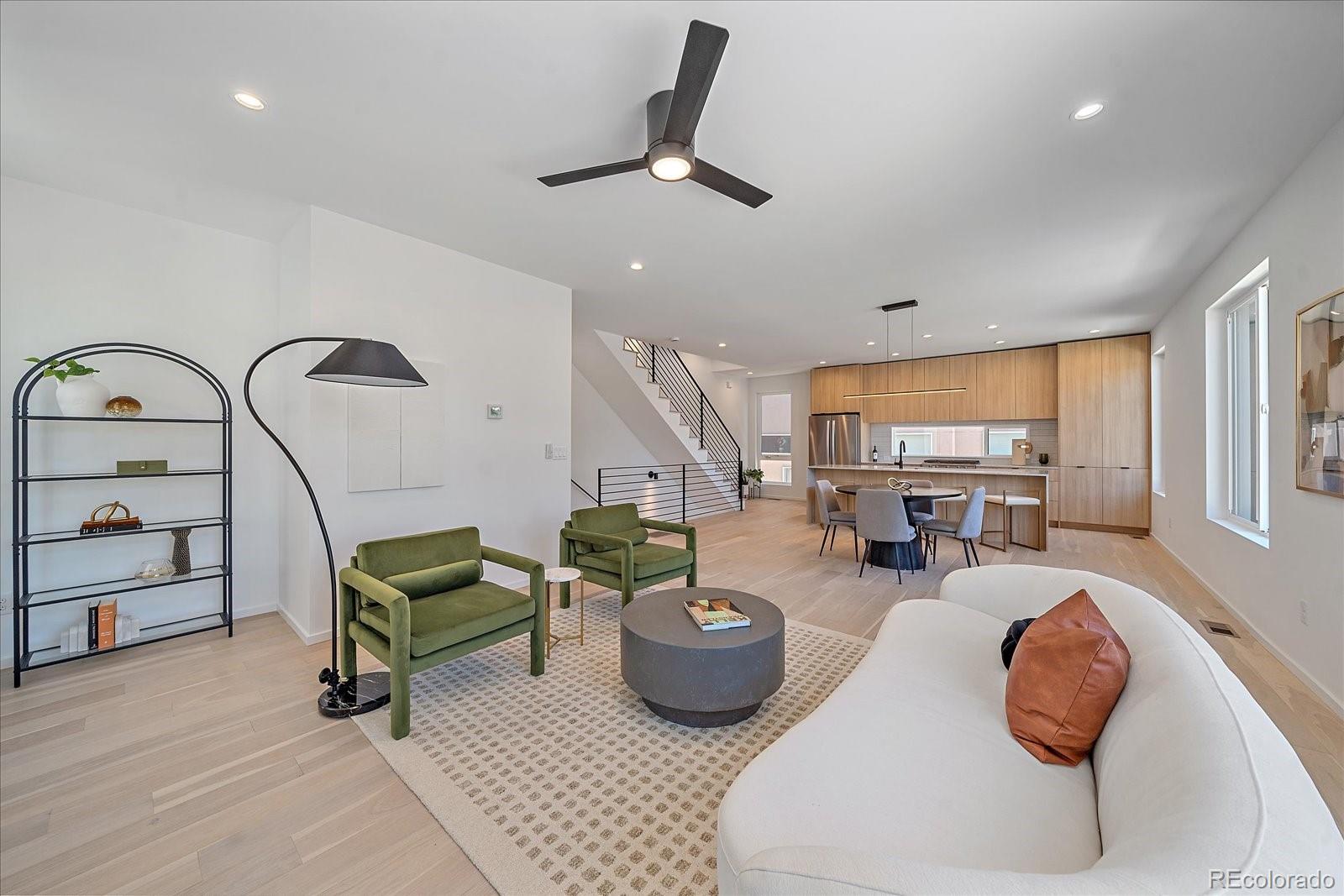 a living room with furniture a rug and white walls