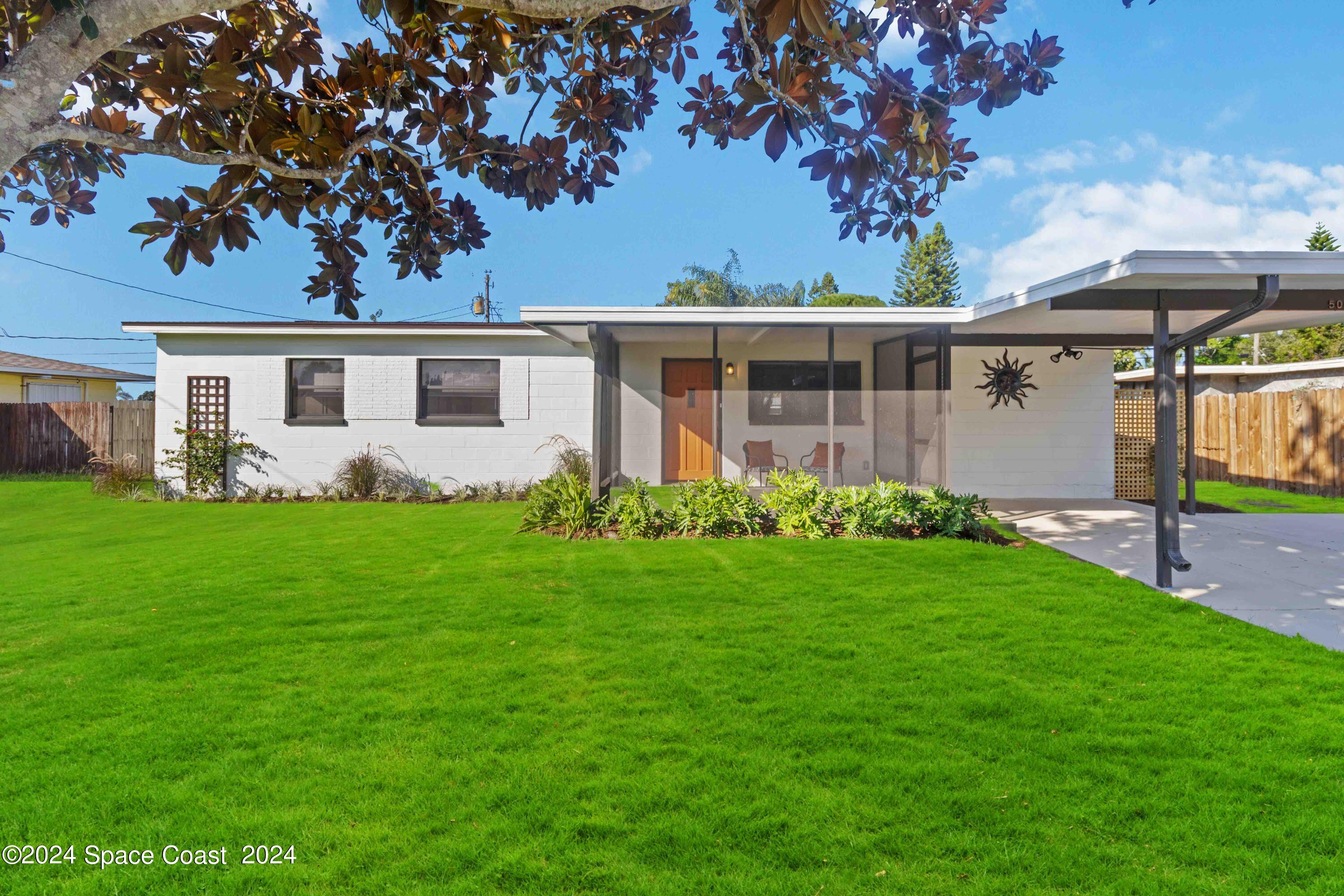 a front view of house with yard and green space