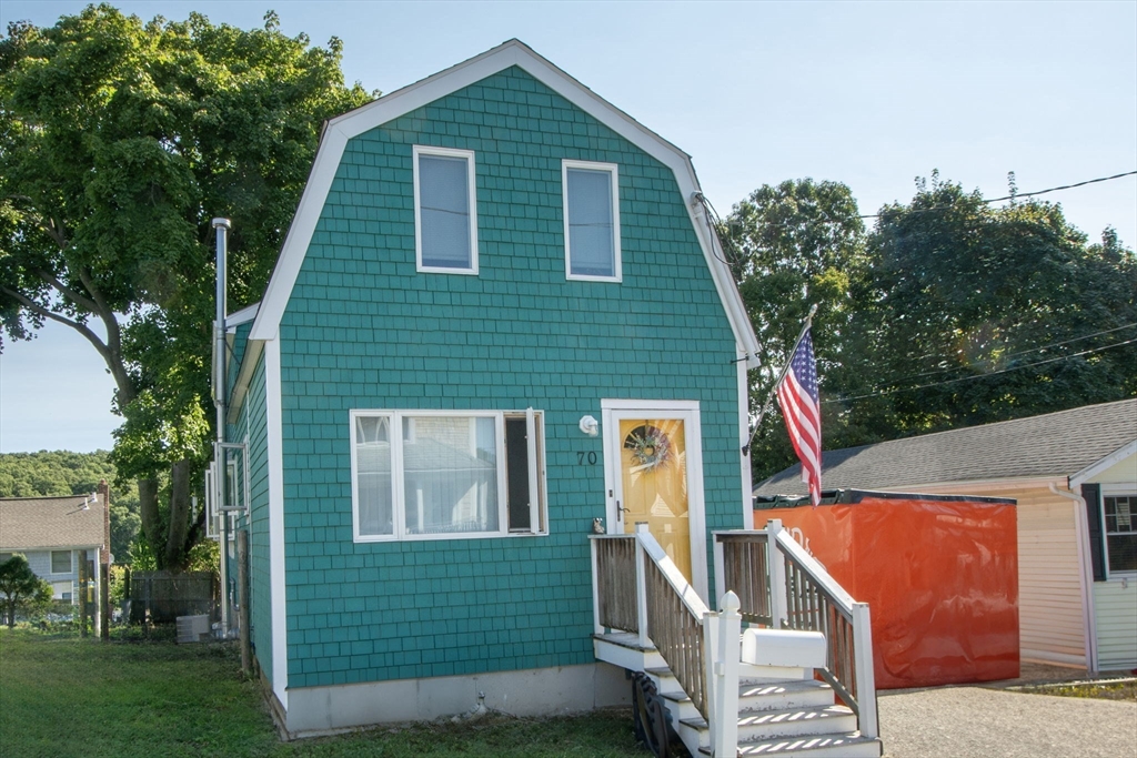 a front view of a house with garden