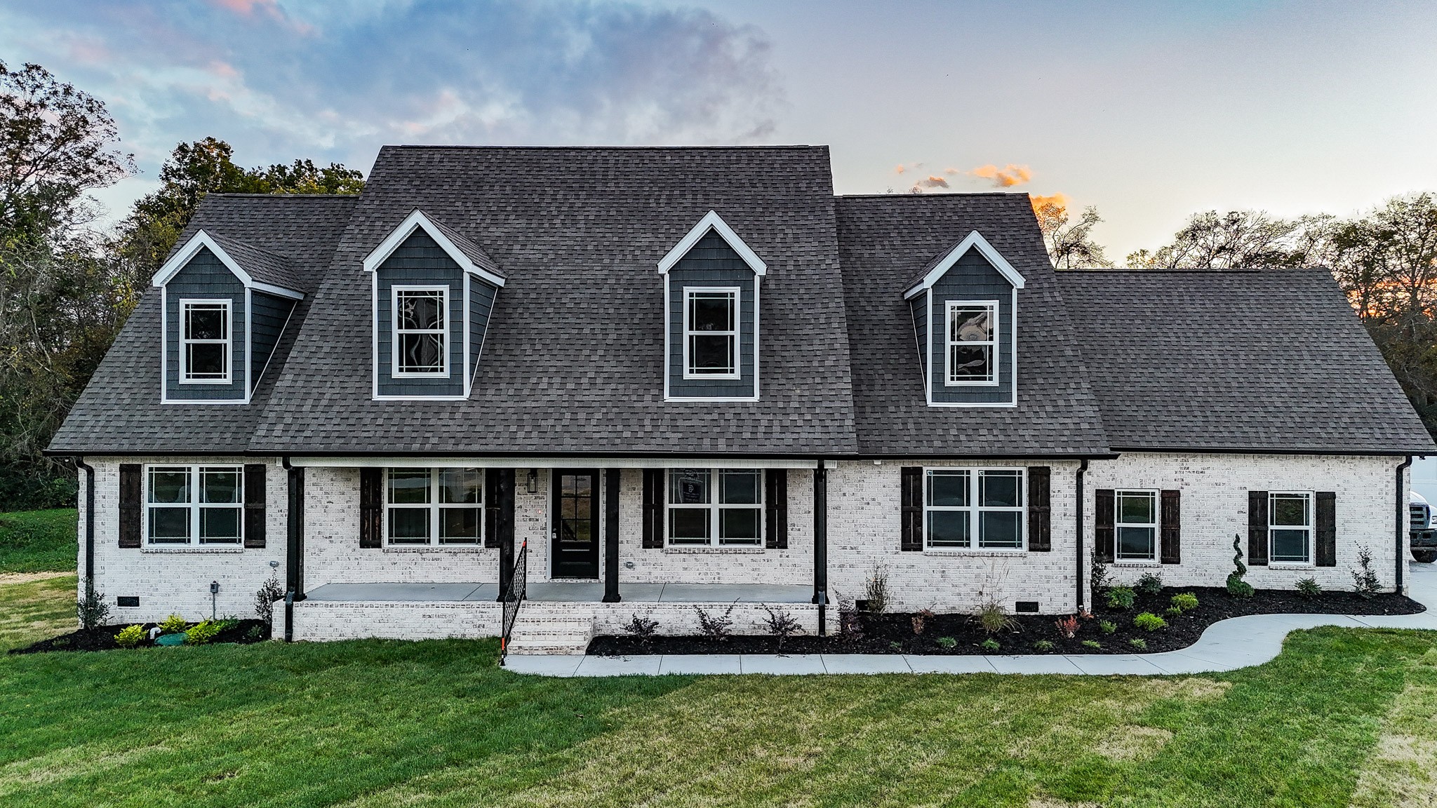 a front view of a house with a yard