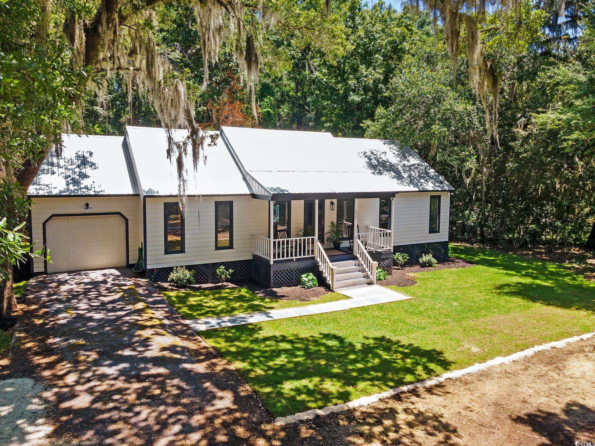 View of front facade with a porch, a garage, and a