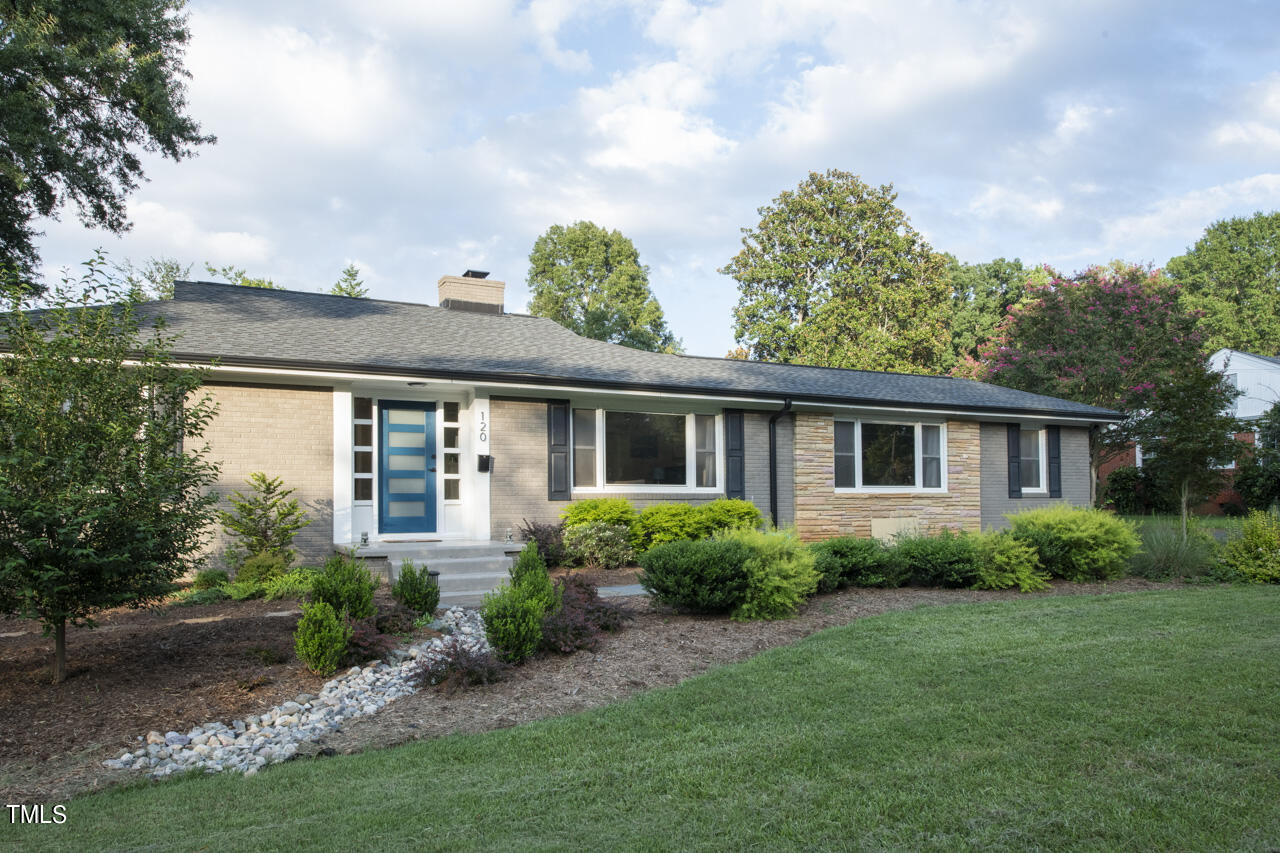 a view of a house with a yard and plants