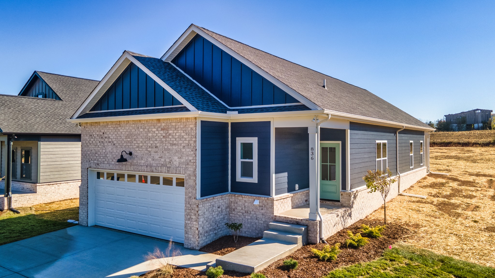 a front view of house with yard outdoor seating and barbeque oven