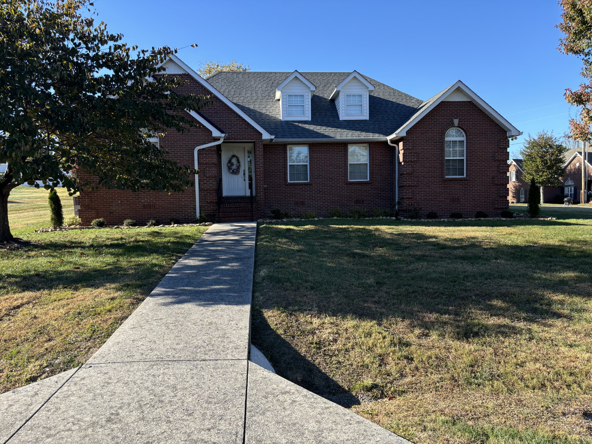 a front view of a house with a yard