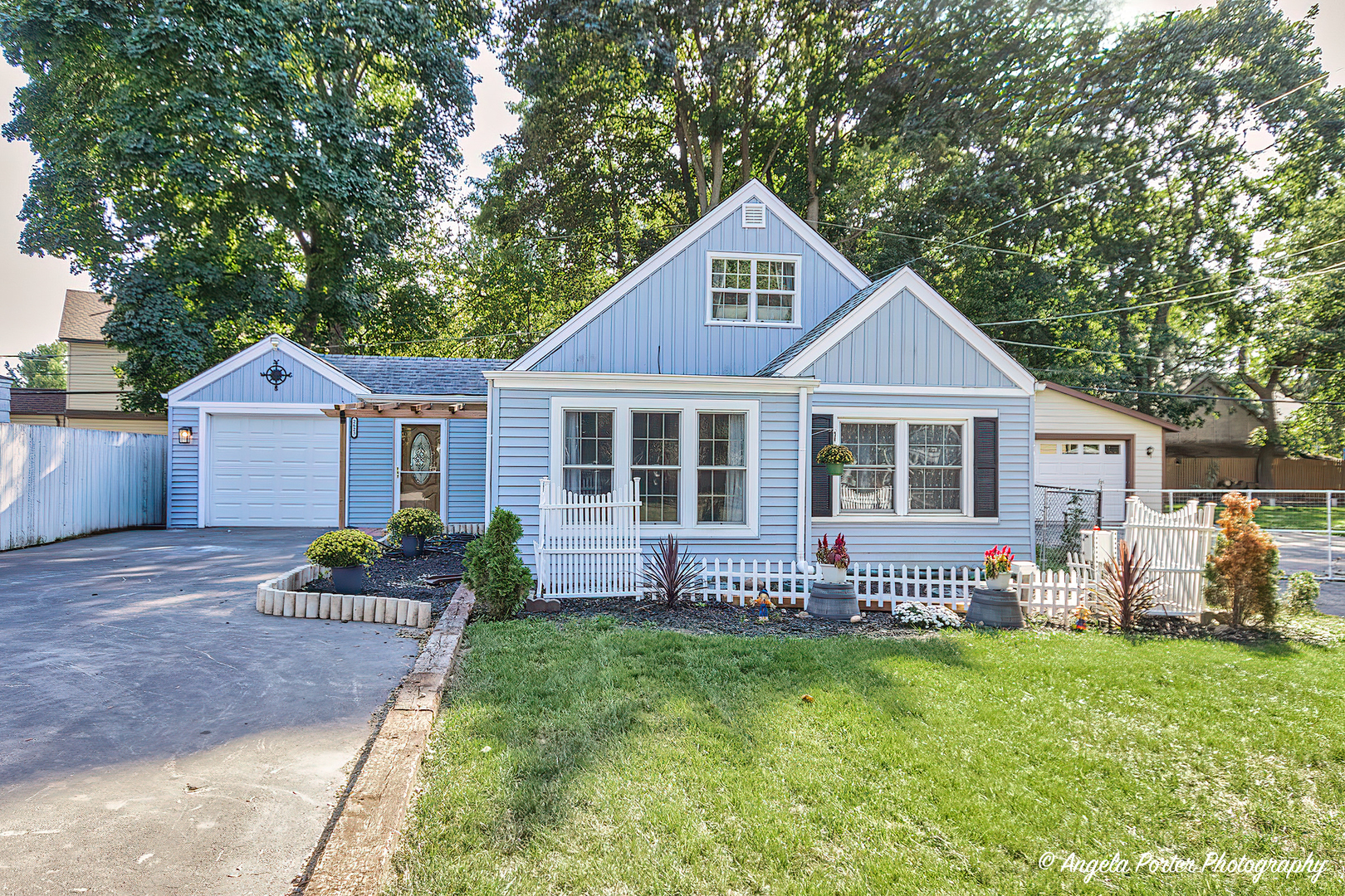 a front view of a house with a garden and porch