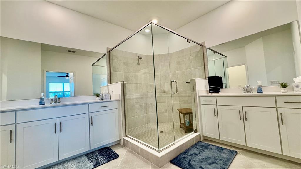 a bathroom with a shower sink and mirror