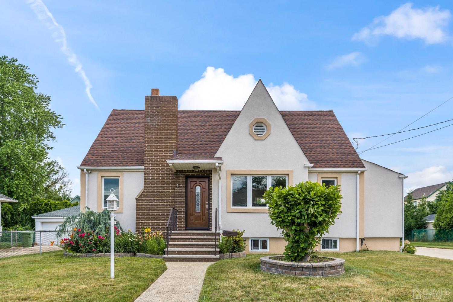 a front view of a house with garden