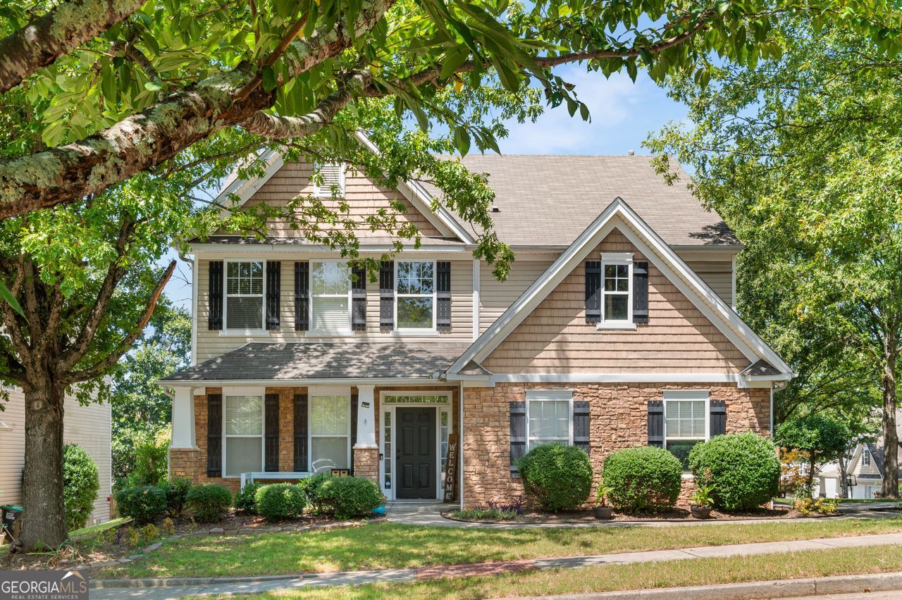 a front view of a house with a garden