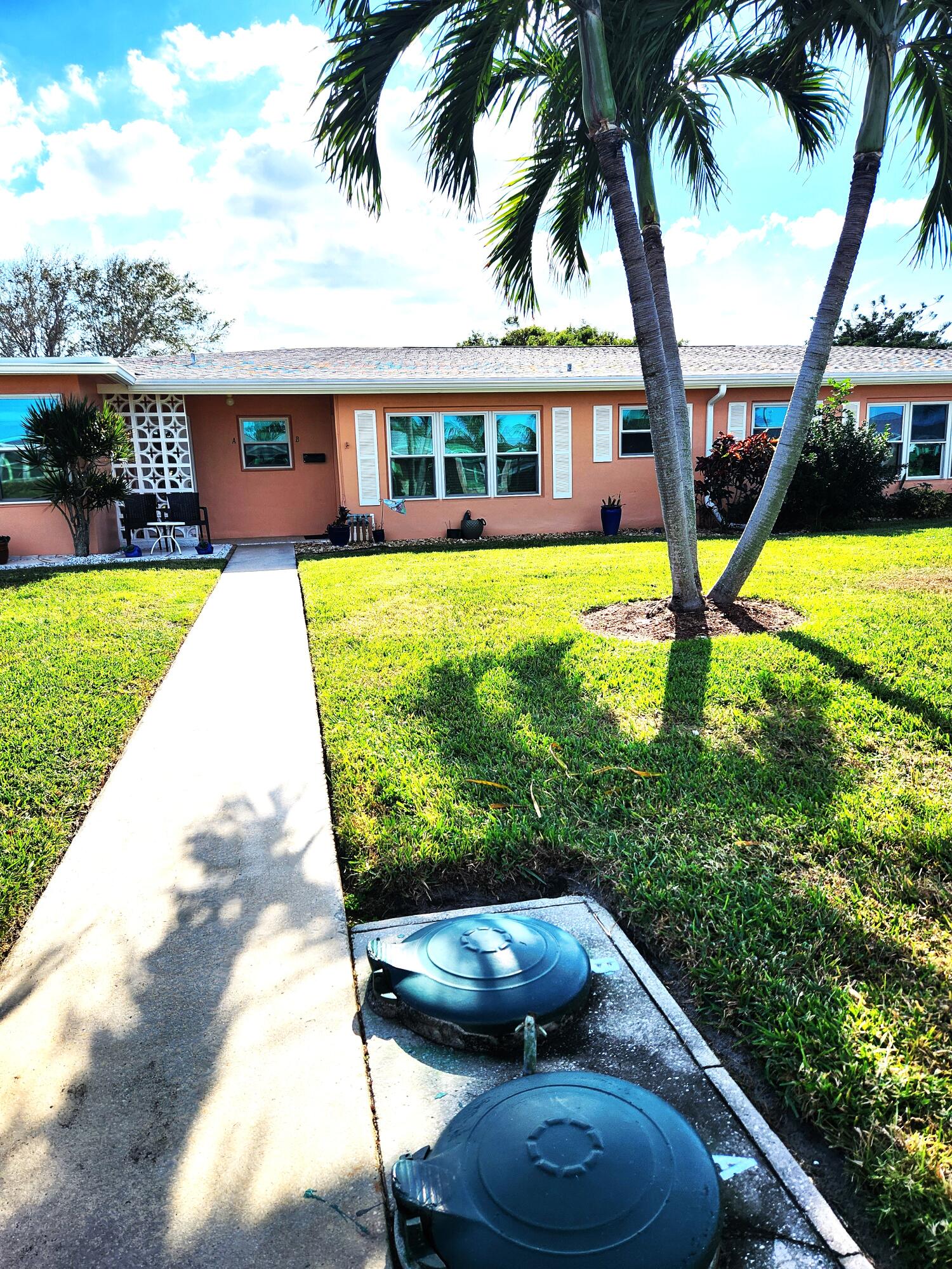 a view of a house with backyard from a swimming pool