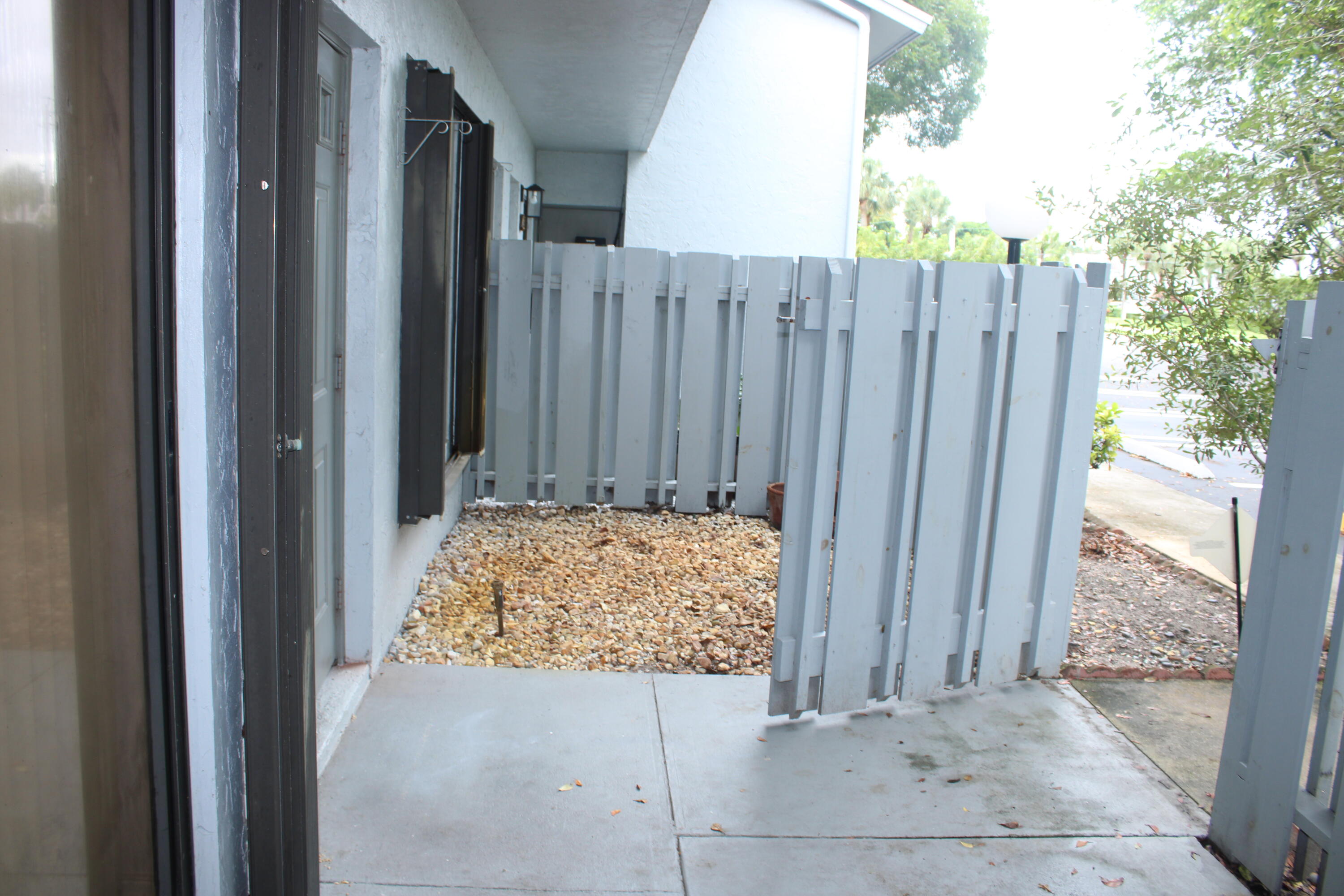 a view of backyard with wooden fence