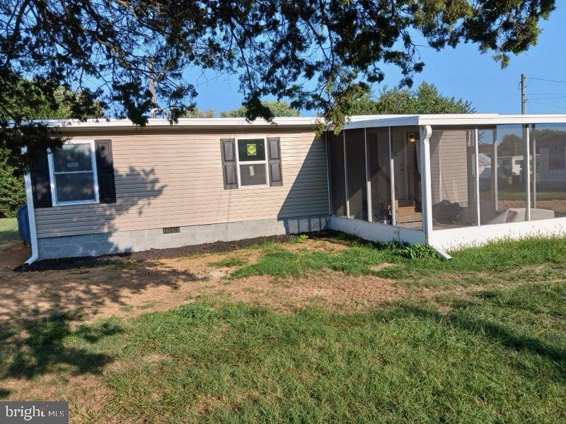 a view of backyard with small cabin