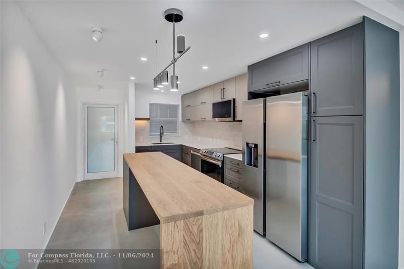 a kitchen with refrigerator and windows