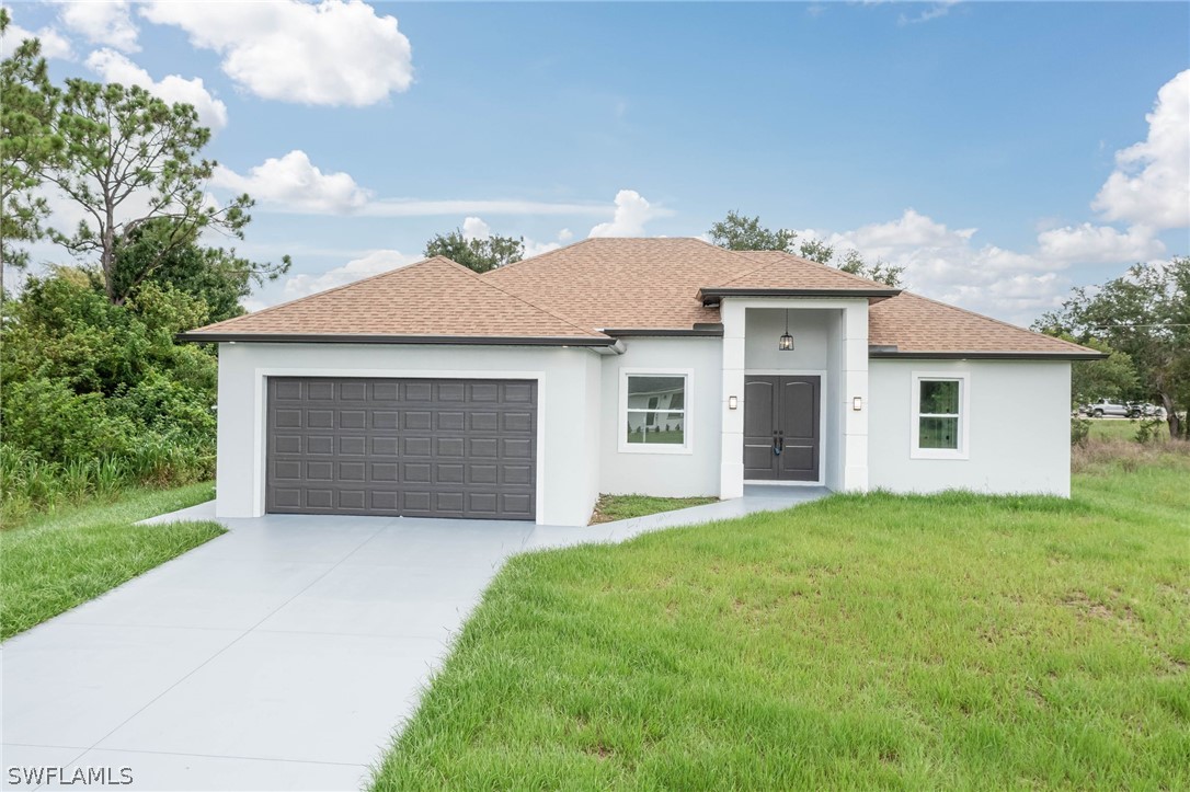 a front view of a house with a yard and garage