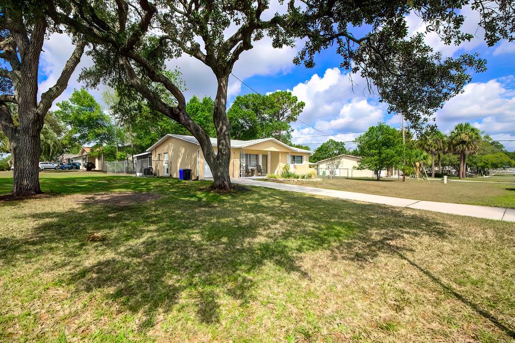 a view of a house with yard and tree s