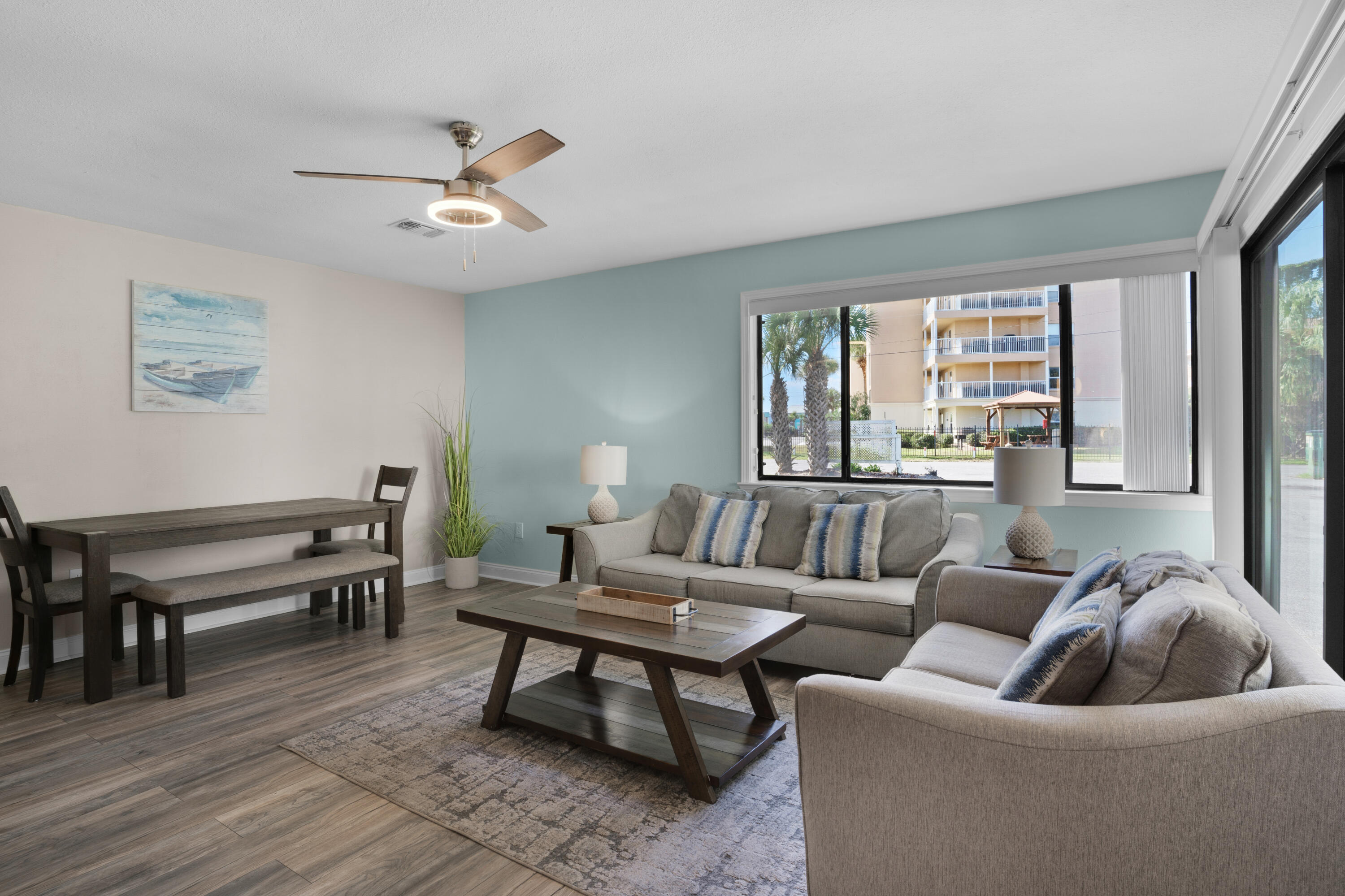 a living room with furniture and a wooden floor