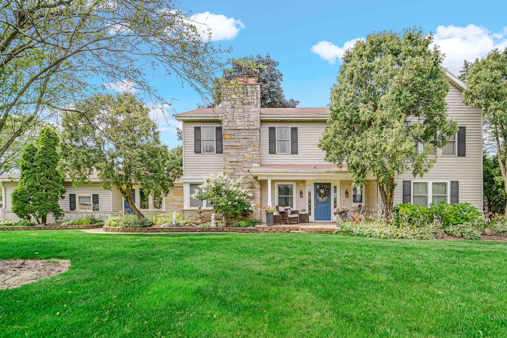 a front view of house with yard and green space