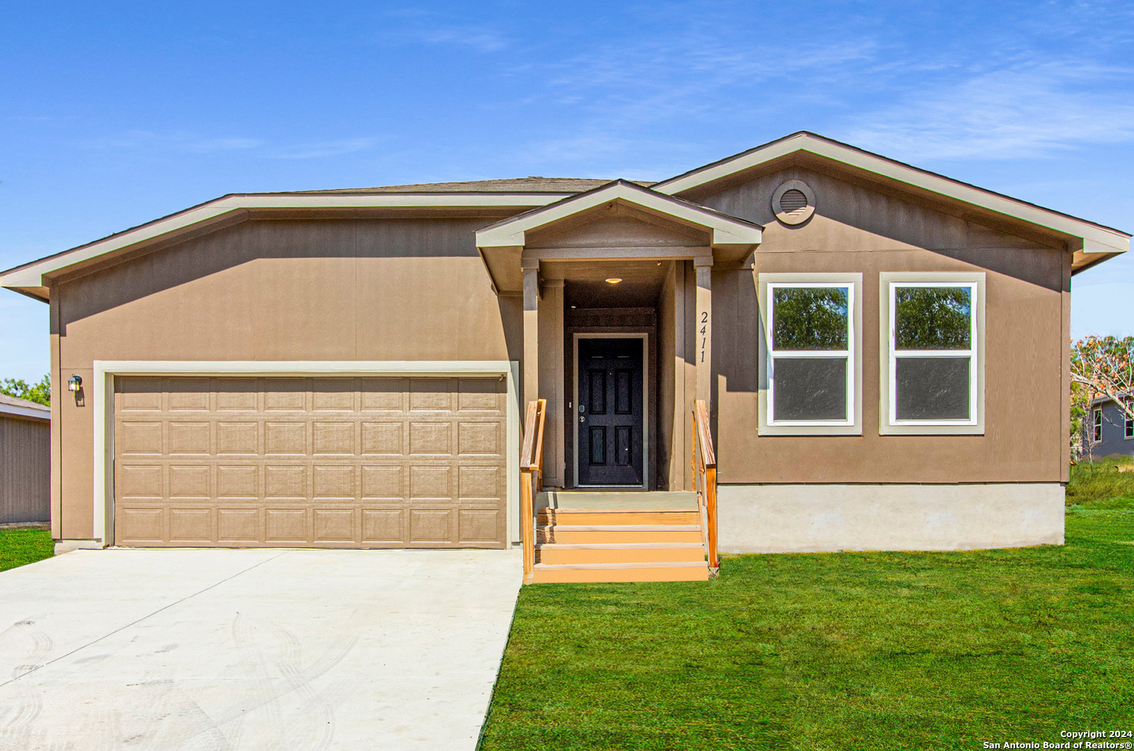 a front view of a house with a yard