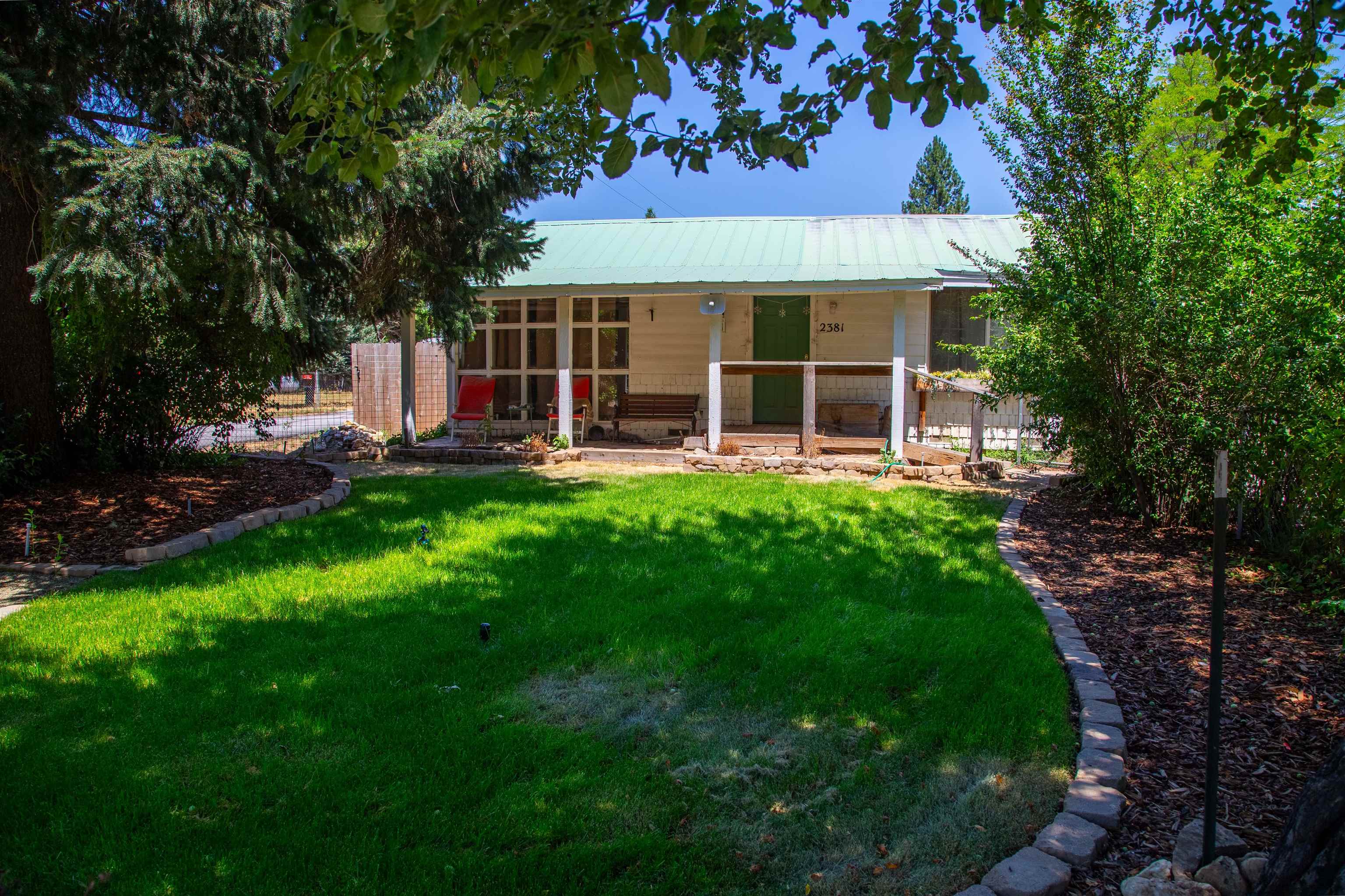 a view of a house with a yard and sitting area