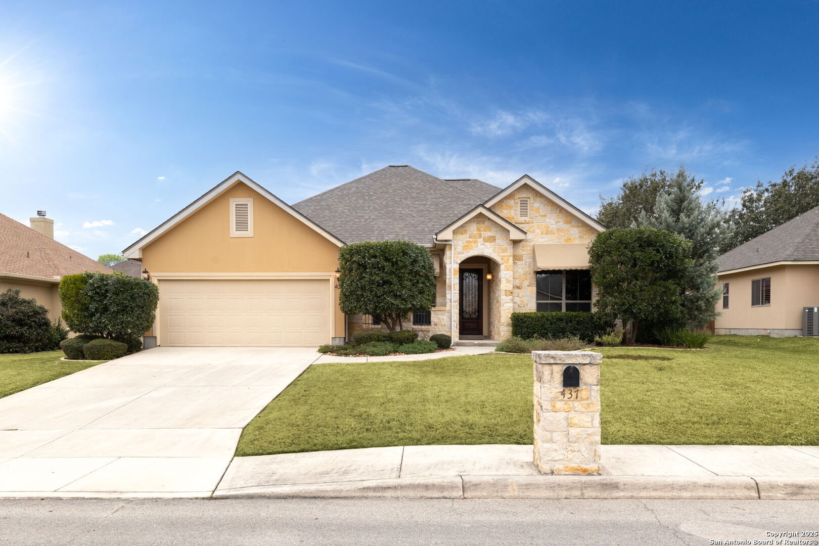 a front view of a house with a yard and garage