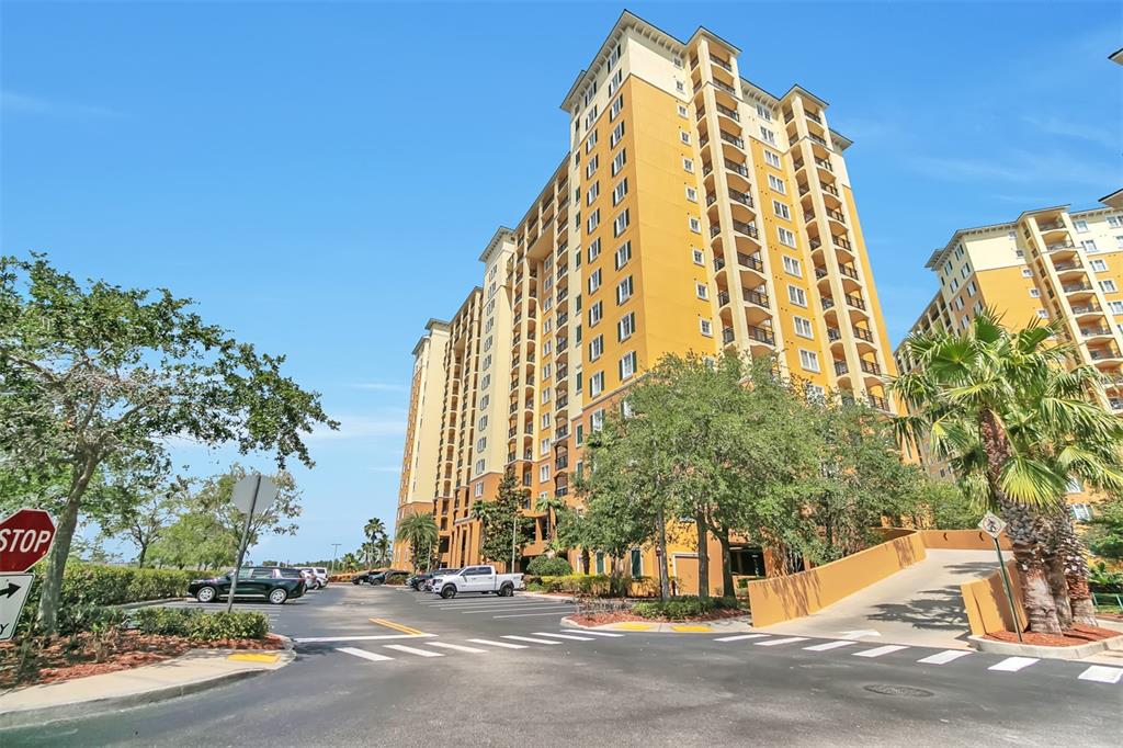 a view of a tall building next to a road