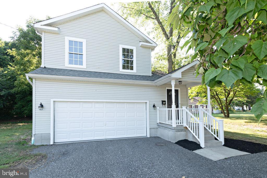 a view of a house with a yard and garage