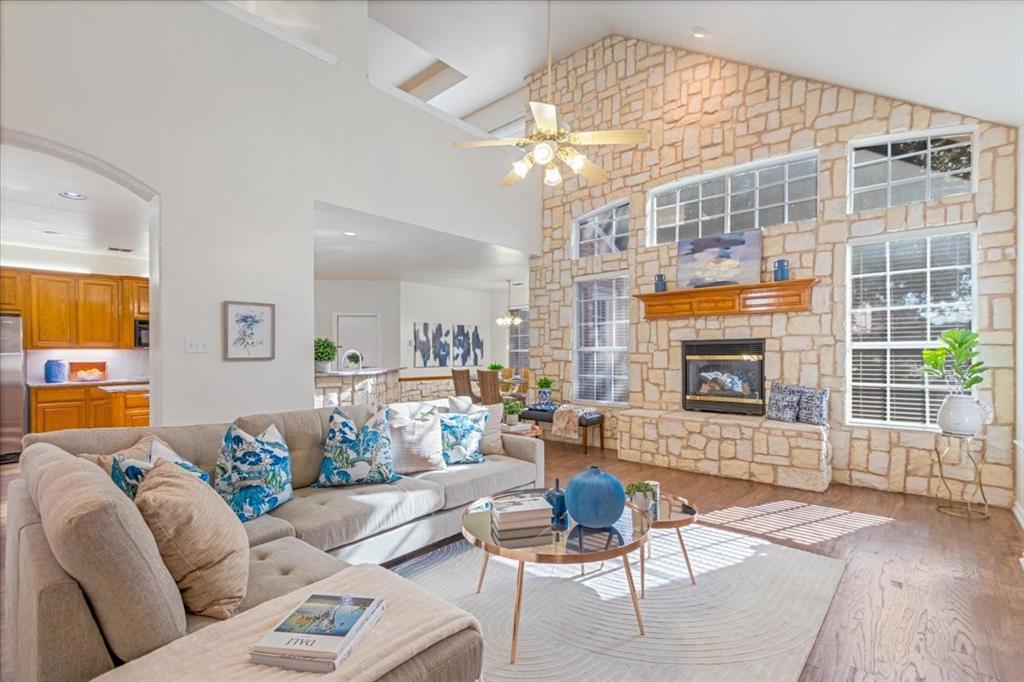 a living room with furniture a flat screen tv and a table