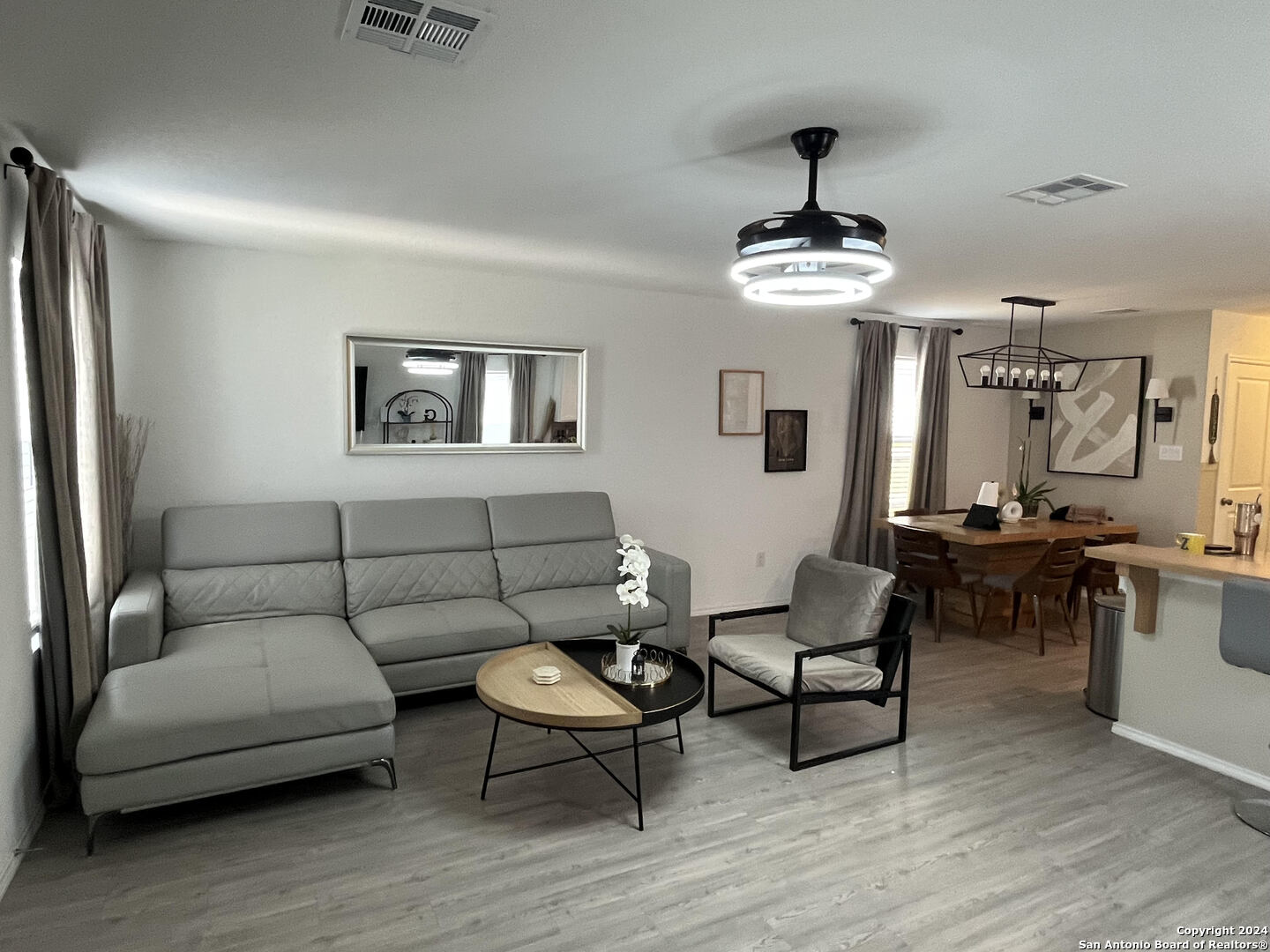 a living room with furniture and a chandelier