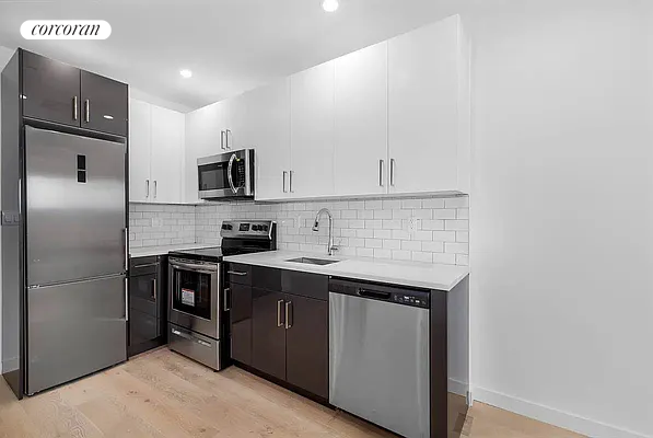 a kitchen with stainless steel appliances a sink stove refrigerator and cabinets