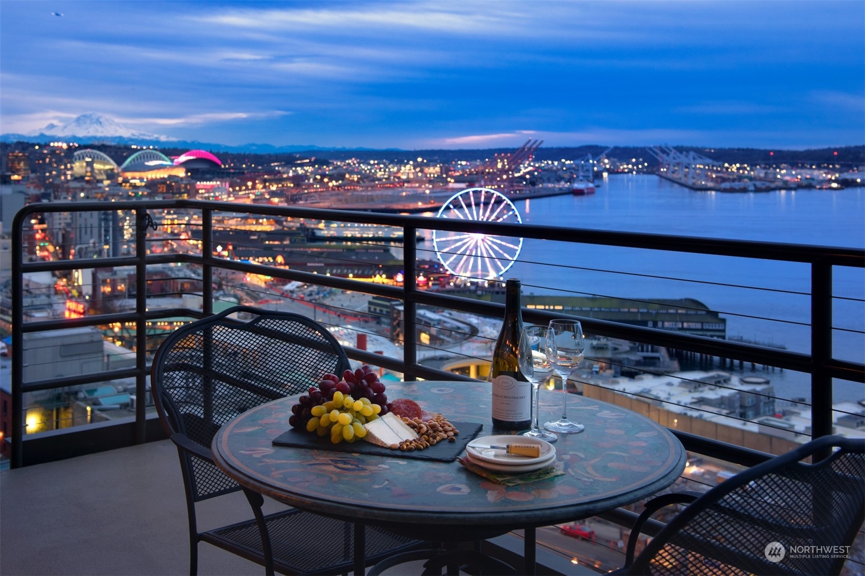 a view of a balcony with dining table and chairs