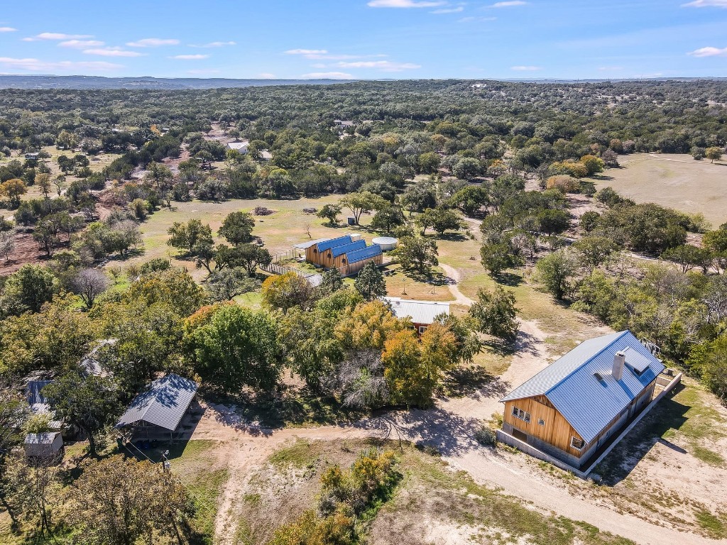 an aerial view of residential house with yard and mountain view in back