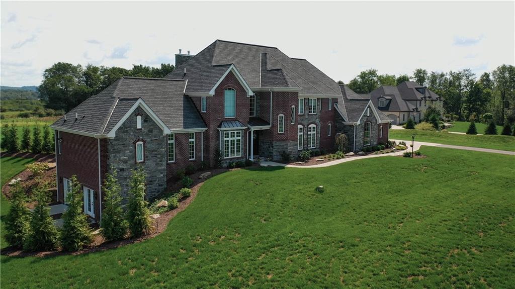 a front view of house with yard and green space