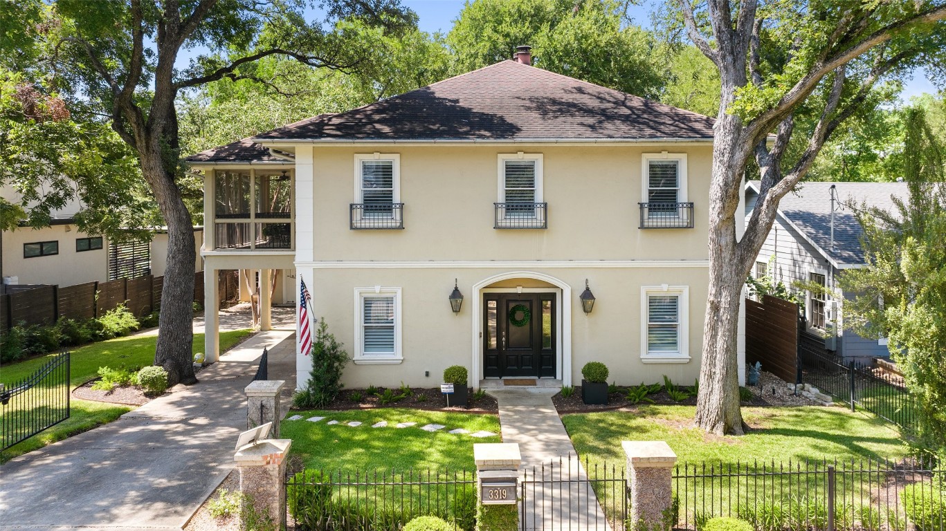 Lush landscaping, a porte cocher with additional covered parking (in addition to an large two car garage!) and a large lot invite you inside