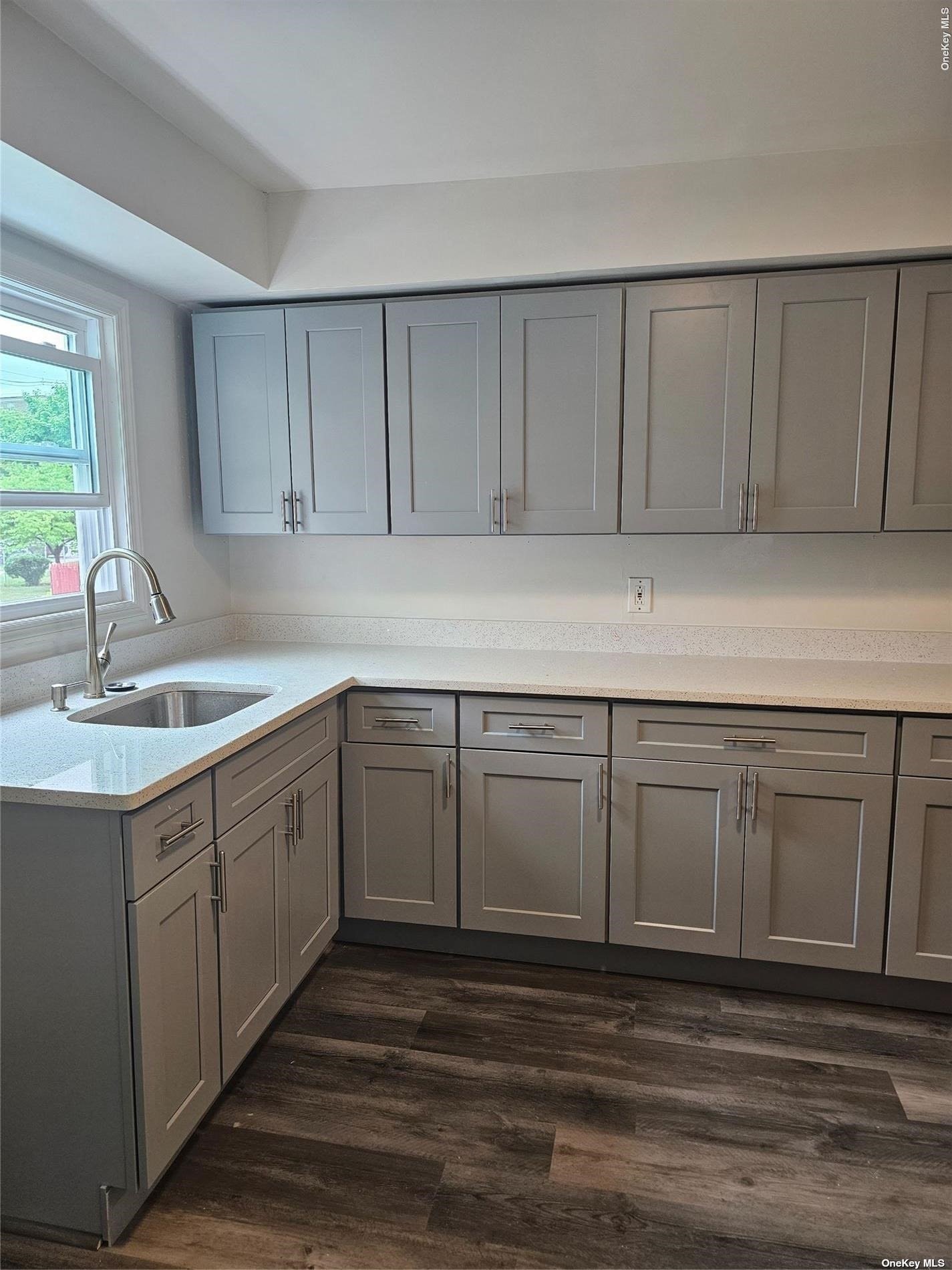 a kitchen with a sink cabinets and window