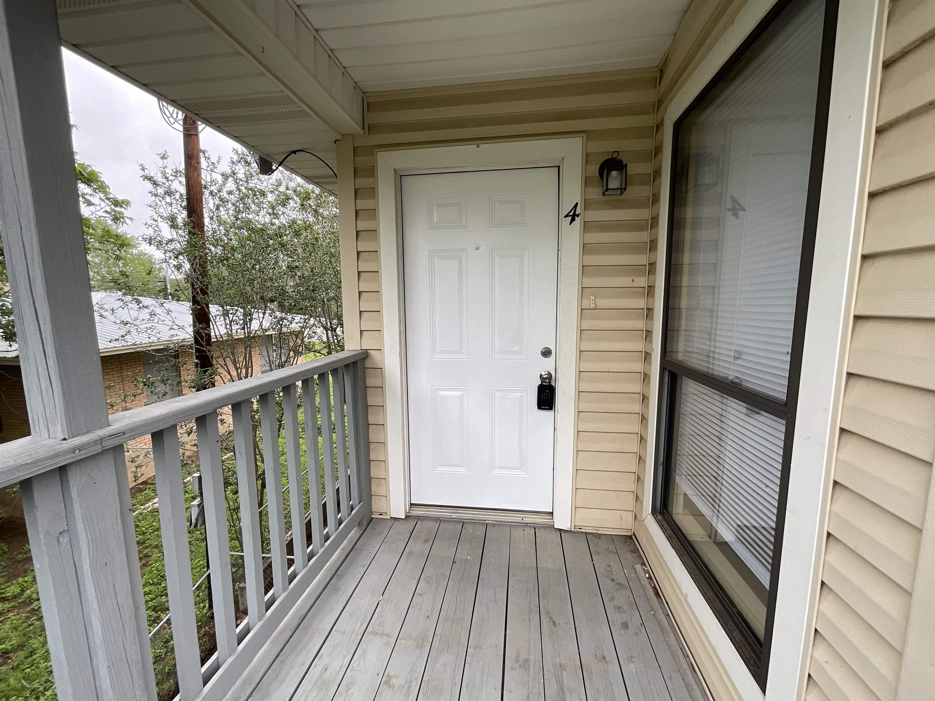 a view of a balcony with wooden floor