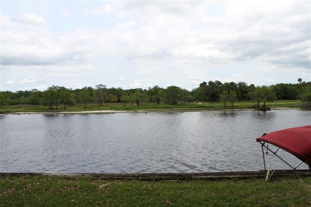 a view of a lake with houses in the background