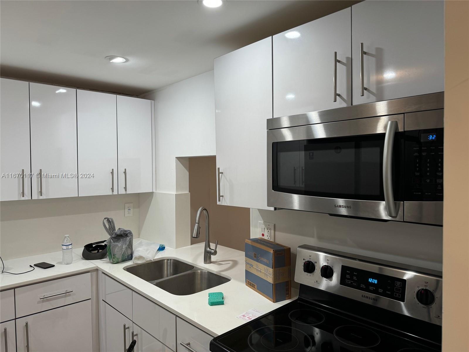 a kitchen with a stove and a microwave