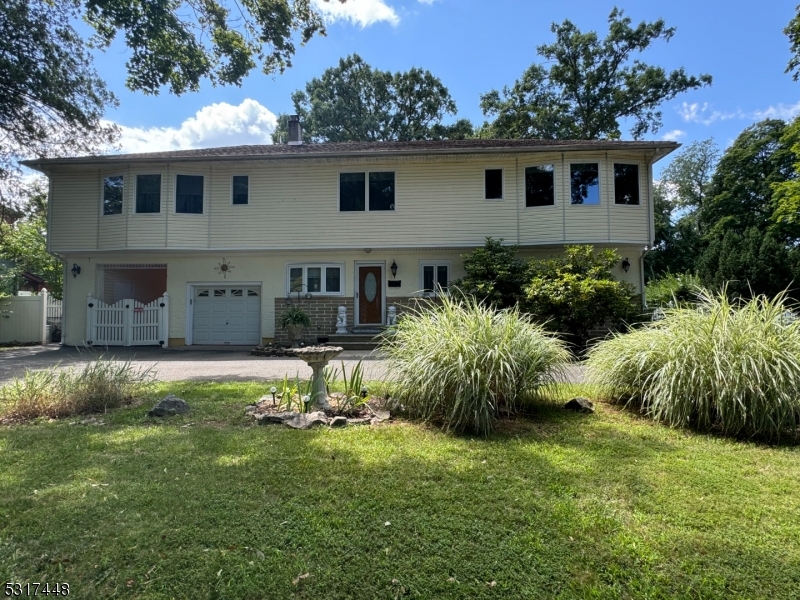 a view of a house with a yard and plants