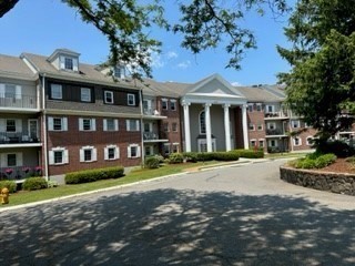 a front view of a building with a garden