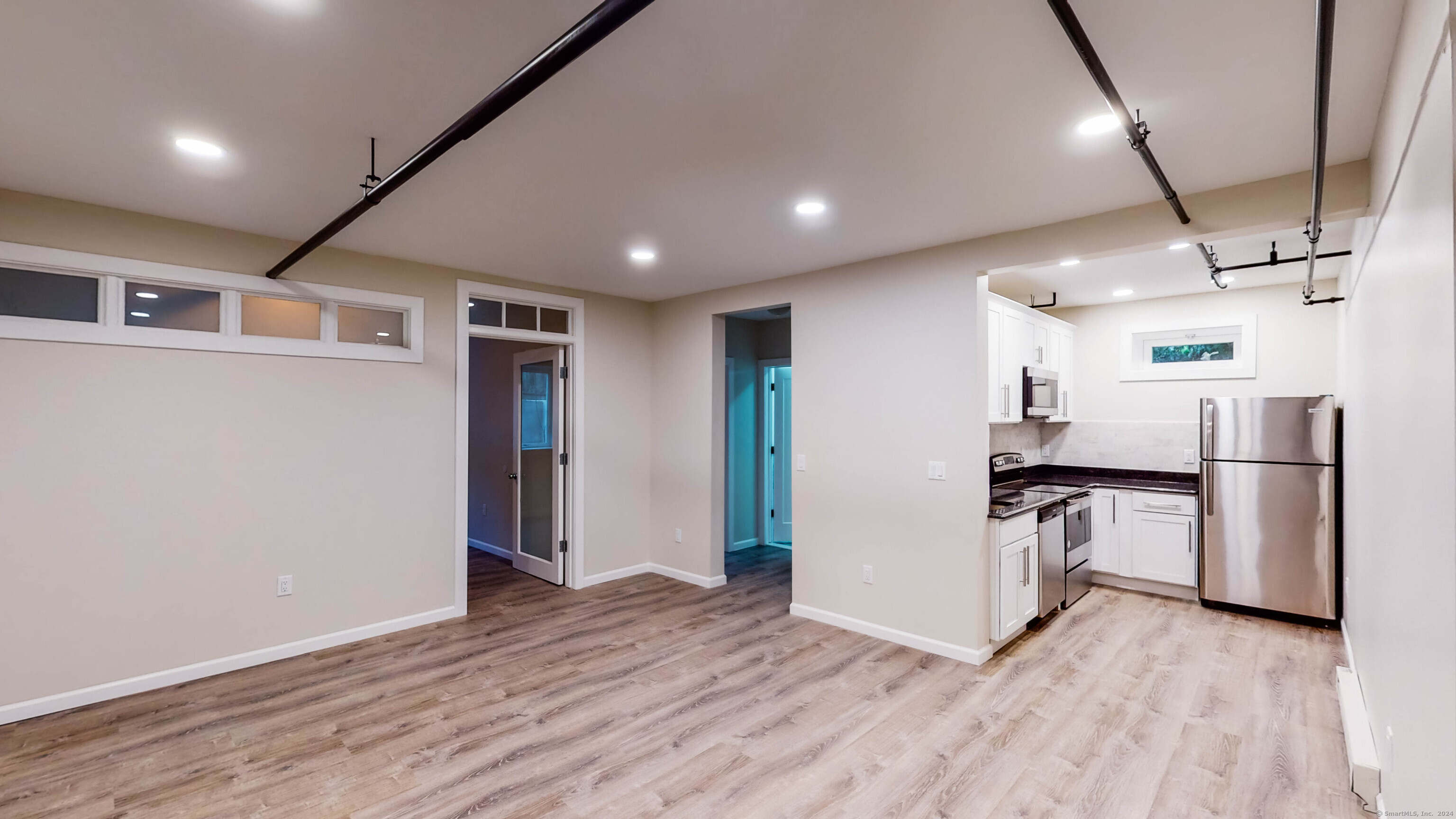 a view of a refrigerator in kitchen and wooden floor